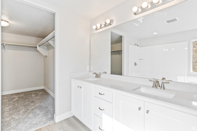 387 Slant Road, Unit 30 Spanish Fork, UT 84660 - Photo 18 of 25 Double vanity with white cabinetry, light-toned countertops, and brushed nickel fixtures