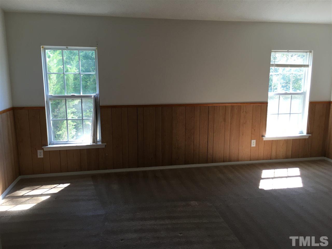 4841 Heatherfield Way Raleigh, NC 27604 - Photo 12 of 23 an empty room with wooden floor and windows