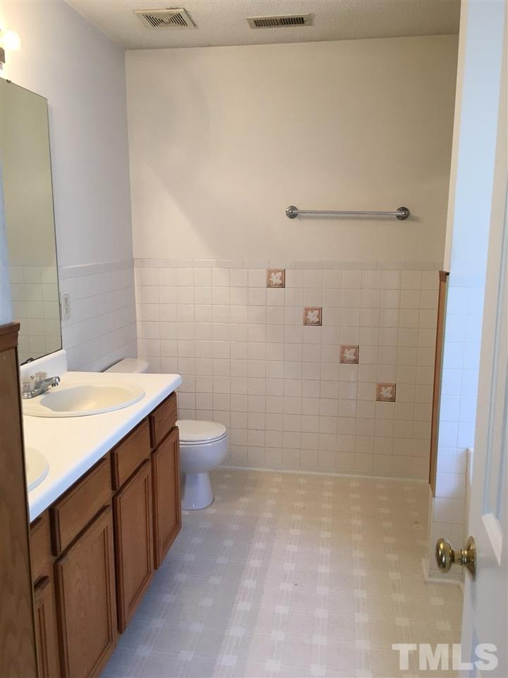 4841 Heatherfield Way Raleigh, NC 27604 - Photo 13 of 23 a bathroom with a sink a toilet and shower