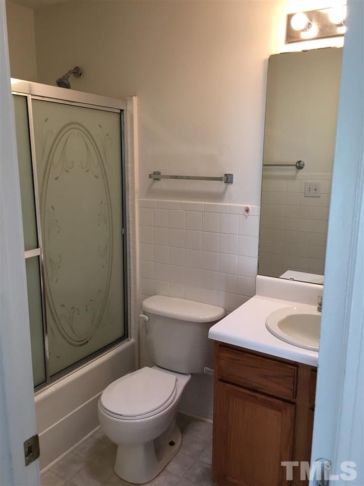 4841 Heatherfield Way Raleigh, NC 27604 - Photo 14 of 23 a white toilet sitting next to a bathroom sink