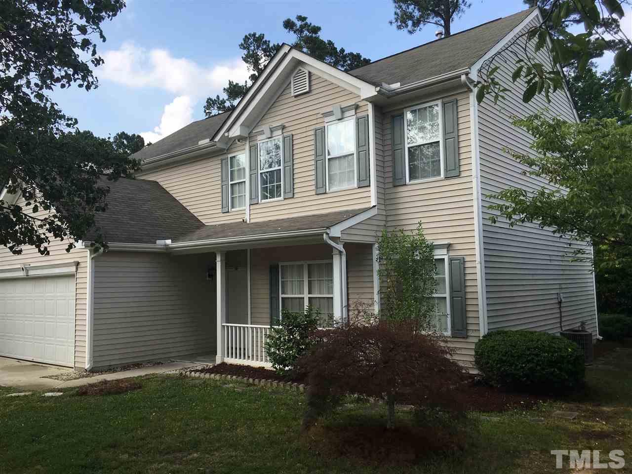 4841 Heatherfield Way Raleigh, NC 27604 - Photo 20 of 23 a front view of a house with a garden and plants