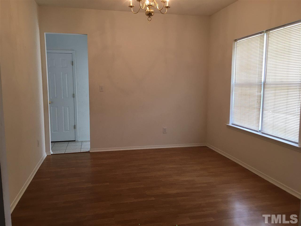 4841 Heatherfield Way Raleigh, NC 27604 - Photo 4 of 23 an empty room with wooden floor and windows