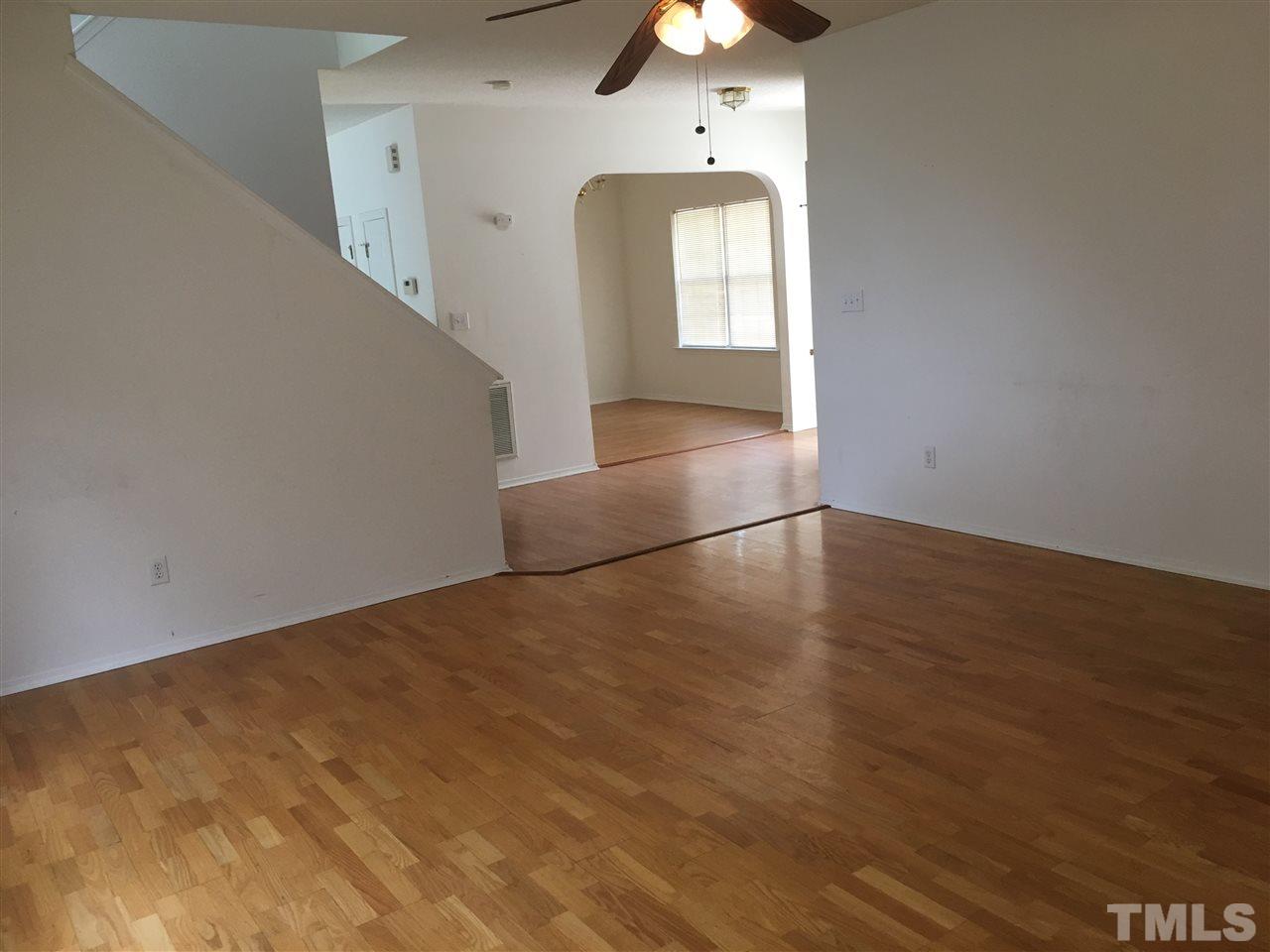 4841 Heatherfield Way Raleigh, NC 27604 - Photo 5 of 23 an empty room with wooden floor and windows