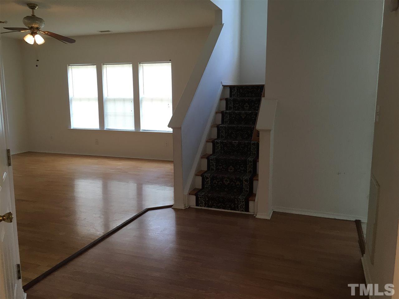 4841 Heatherfield Way Raleigh, NC 27604 - Photo 10 of 23 wooden floor in an empty room with a window