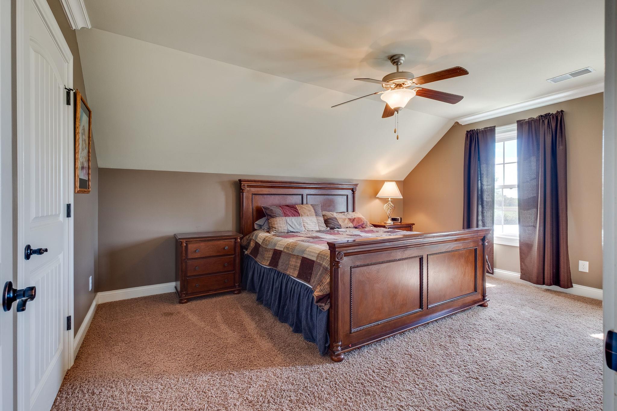 979 Franklin Road Gallatin, TN 37066 - Photo 15 of 24 a bed room with a bed and a ceiling fan