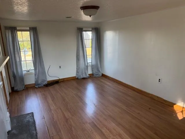 a bed sitting in a bedroom next to a window