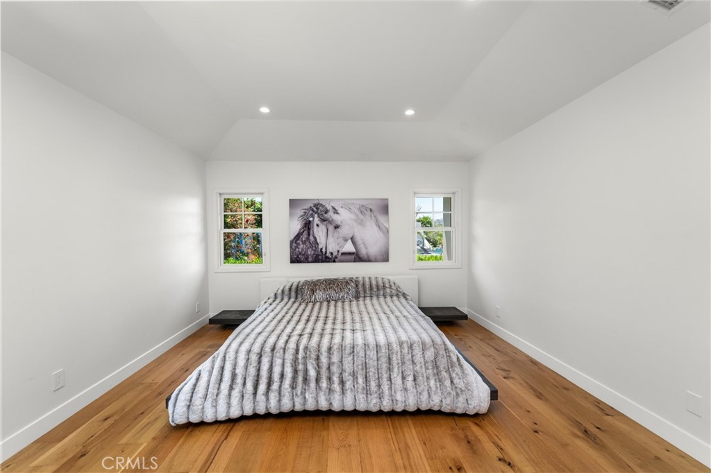 7337 La Soldadera Rancho Santa Fe, CA 92067 - Photo 31 of 60 a bedroom with a bed and wooden floor