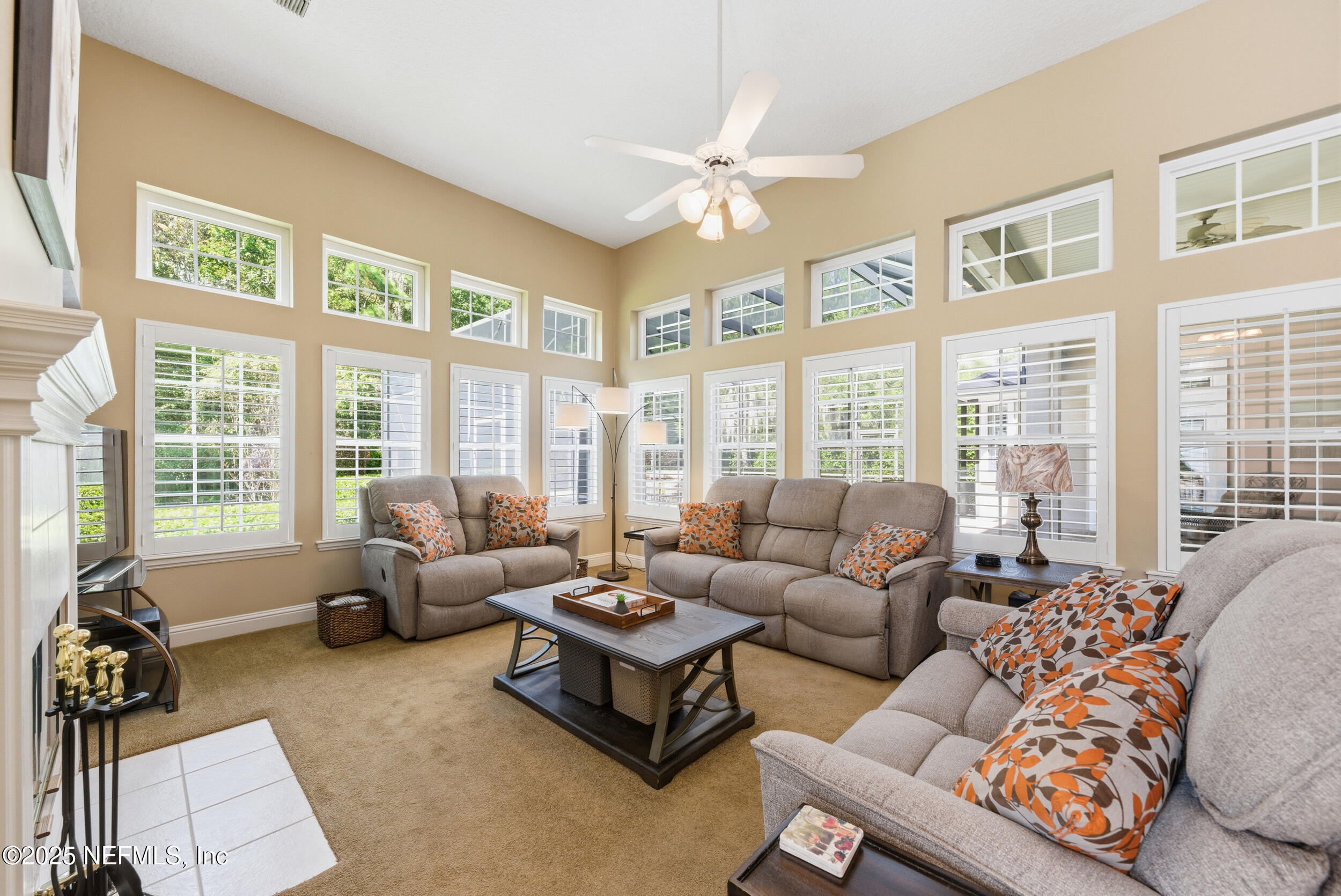 10044 Vineyard Lake Road East Jacksonville, FL 32256 - Photo 15 of 34 a living room with furniture and floor to ceiling windows