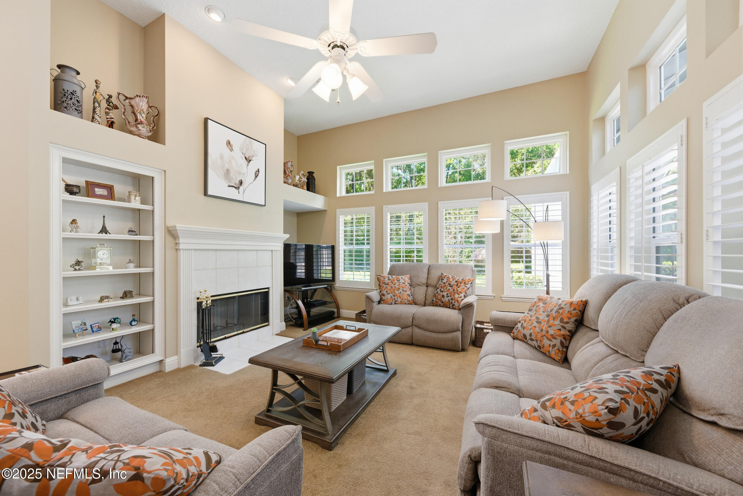 10044 Vineyard Lake Road East Jacksonville, FL 32256 - Photo 16 of 34 a living room with furniture fireplace and a large window
