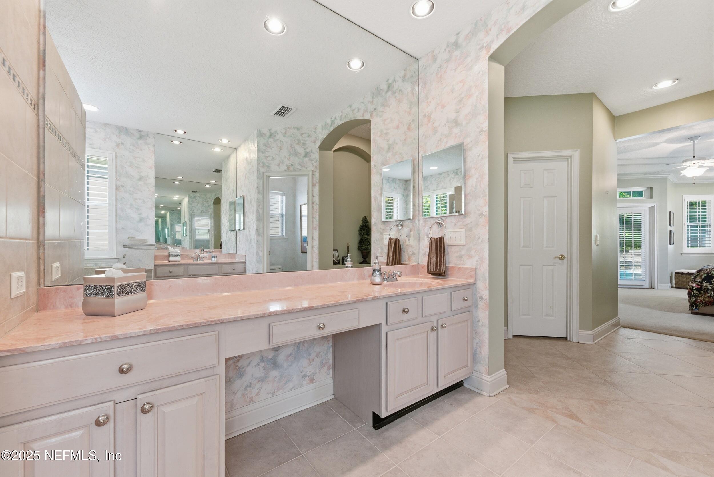 10044 Vineyard Lake Road East Jacksonville, FL 32256 - Photo 21 of 34 a bathroom with a double vanity sink mirror and double