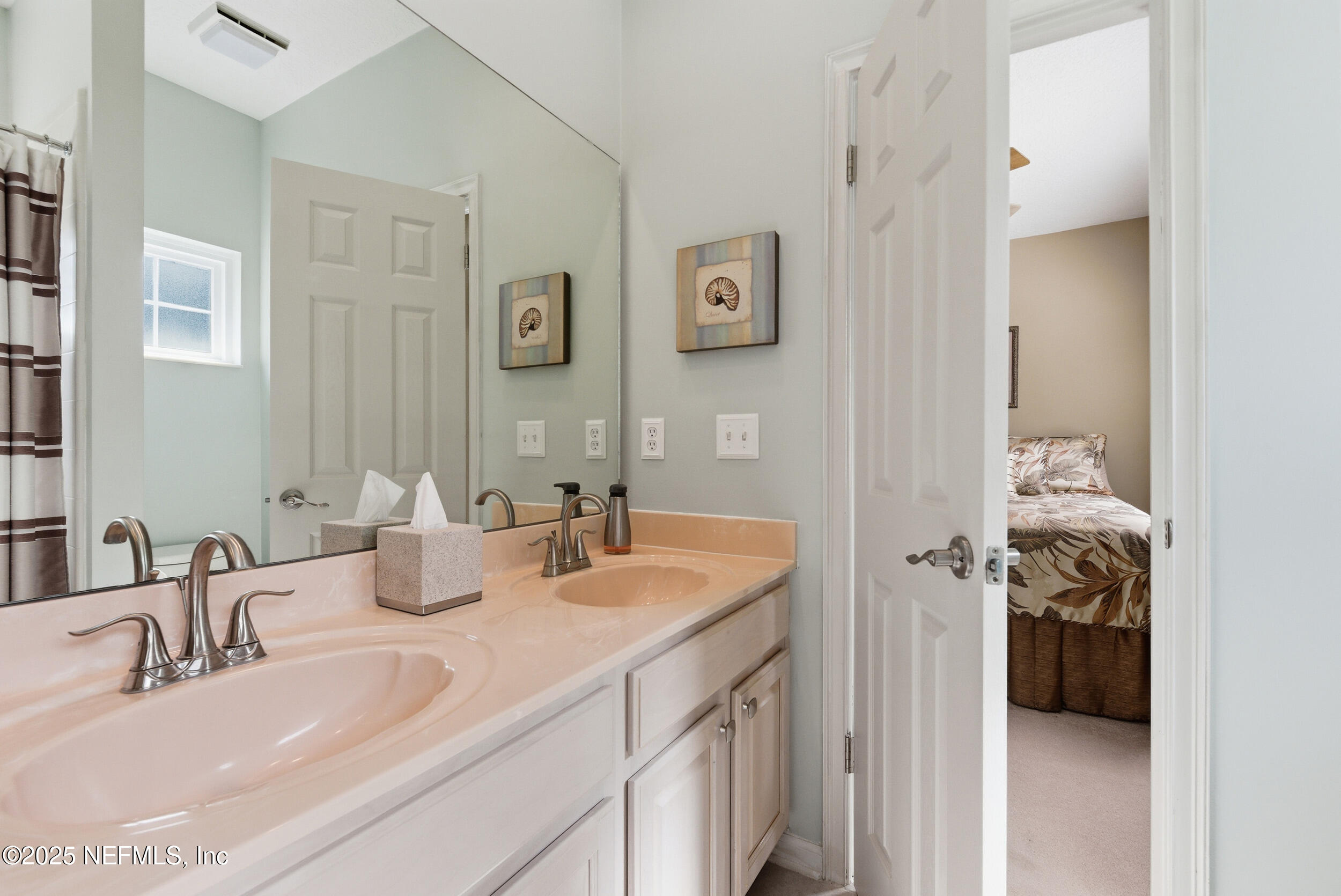 10044 Vineyard Lake Road East Jacksonville, FL 32256 - Photo 24 of 34 a bathroom with a sink and a mirror