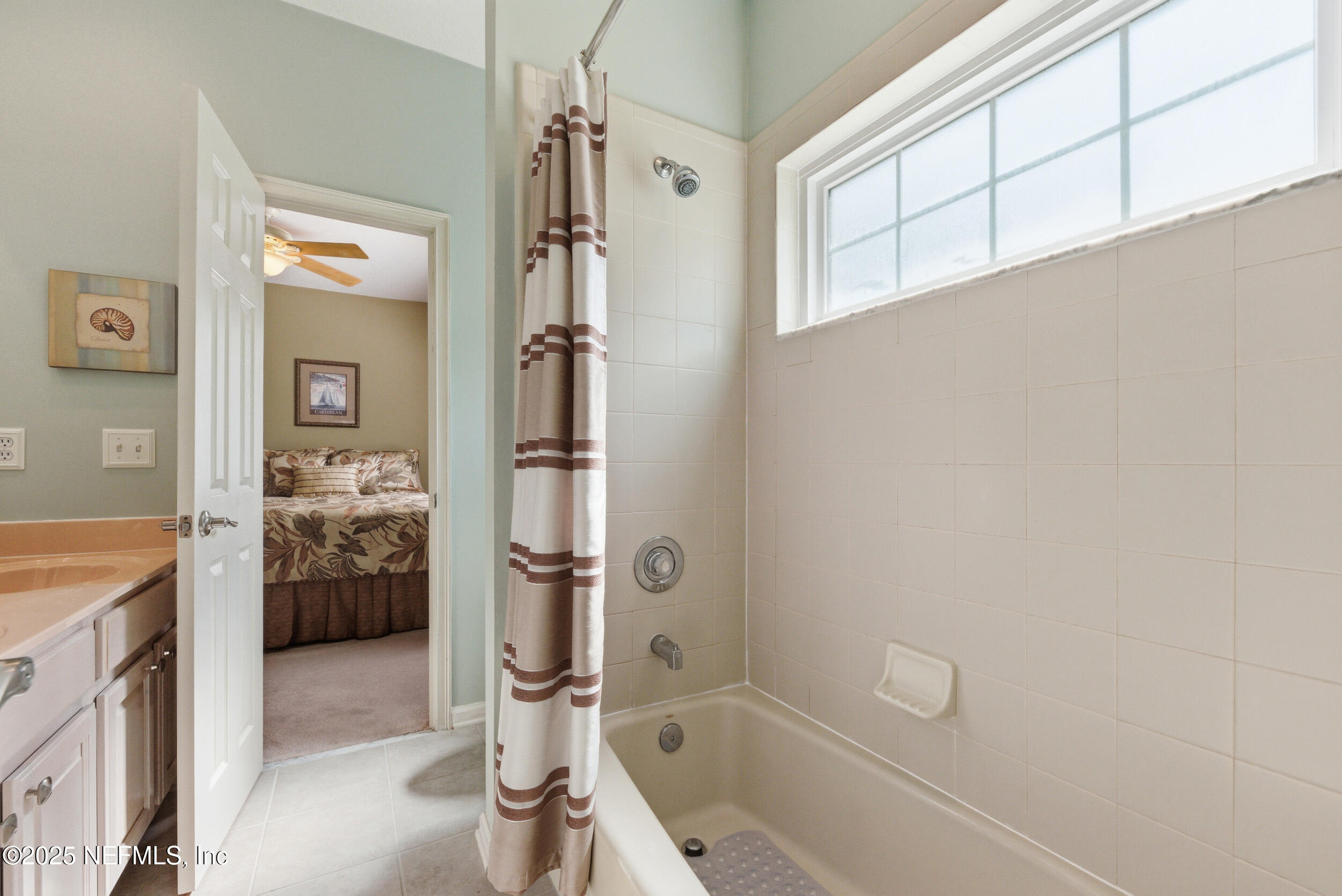 10044 Vineyard Lake Road East Jacksonville, FL 32256 - Photo 25 of 34 a bathroom with a granite countertop tub a sink and a shower