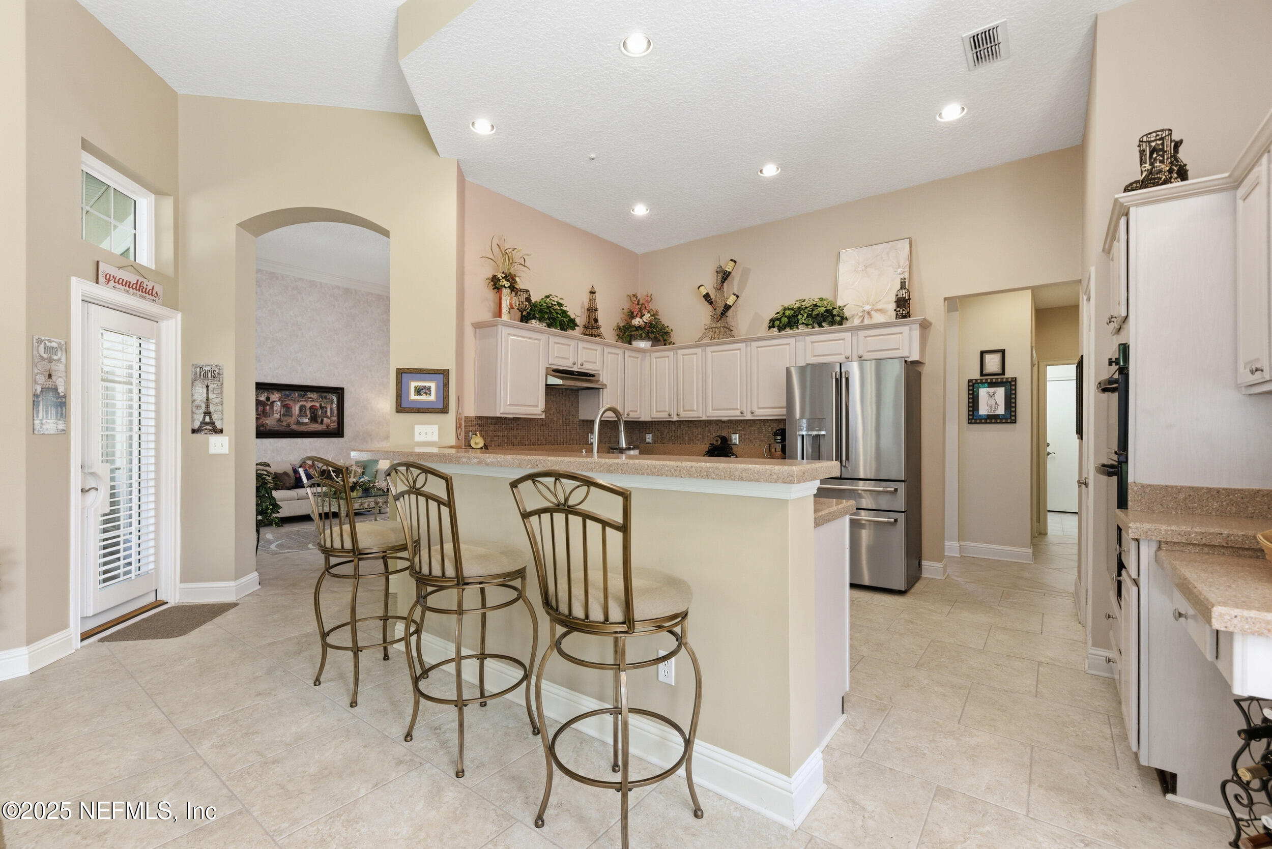10044 Vineyard Lake Road East Jacksonville, FL 32256 - Photo 10 of 34 a kitchen with stainless steel appliances kitchen island granite countertop a refrigerator and microwave