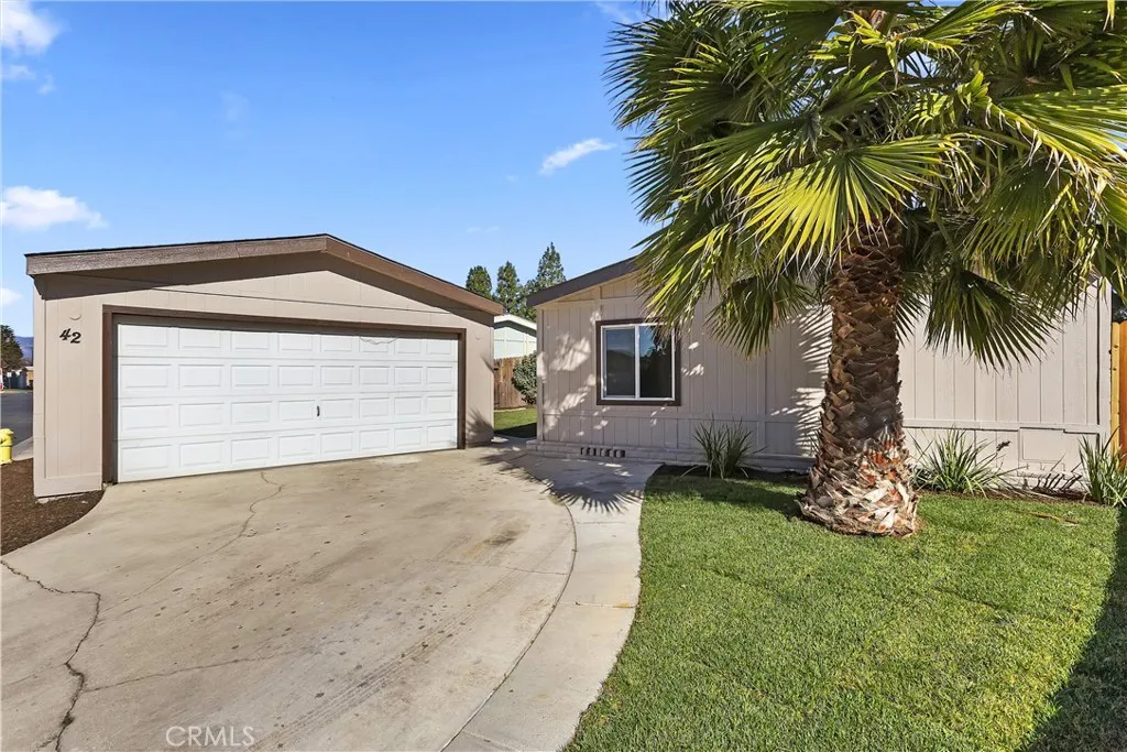 700 East Washington Street Colton, CA 92324 - Photo 1 of 1 a front view of a house with a yard and garage