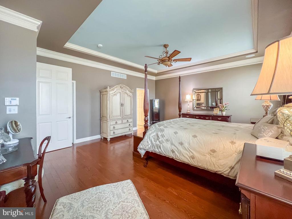 209 Regency Boulevard Yardley, PA 19067 - Photo 17 of 58 a spacious bedroom with a bed a table and chair