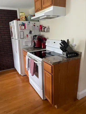 a kitchen with sink cabinets and wooden floor