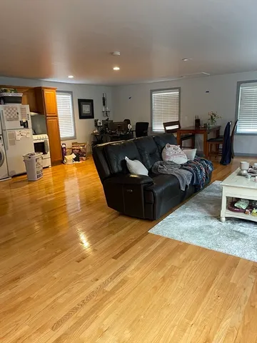 a view of a big house with a big yard and large trees