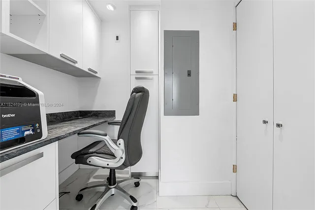 a view of a hallway with workspace and wooden floor