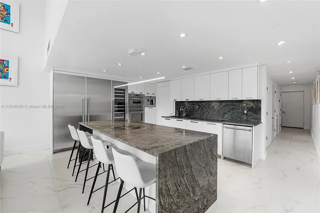 a kitchen with a table and chairs in it