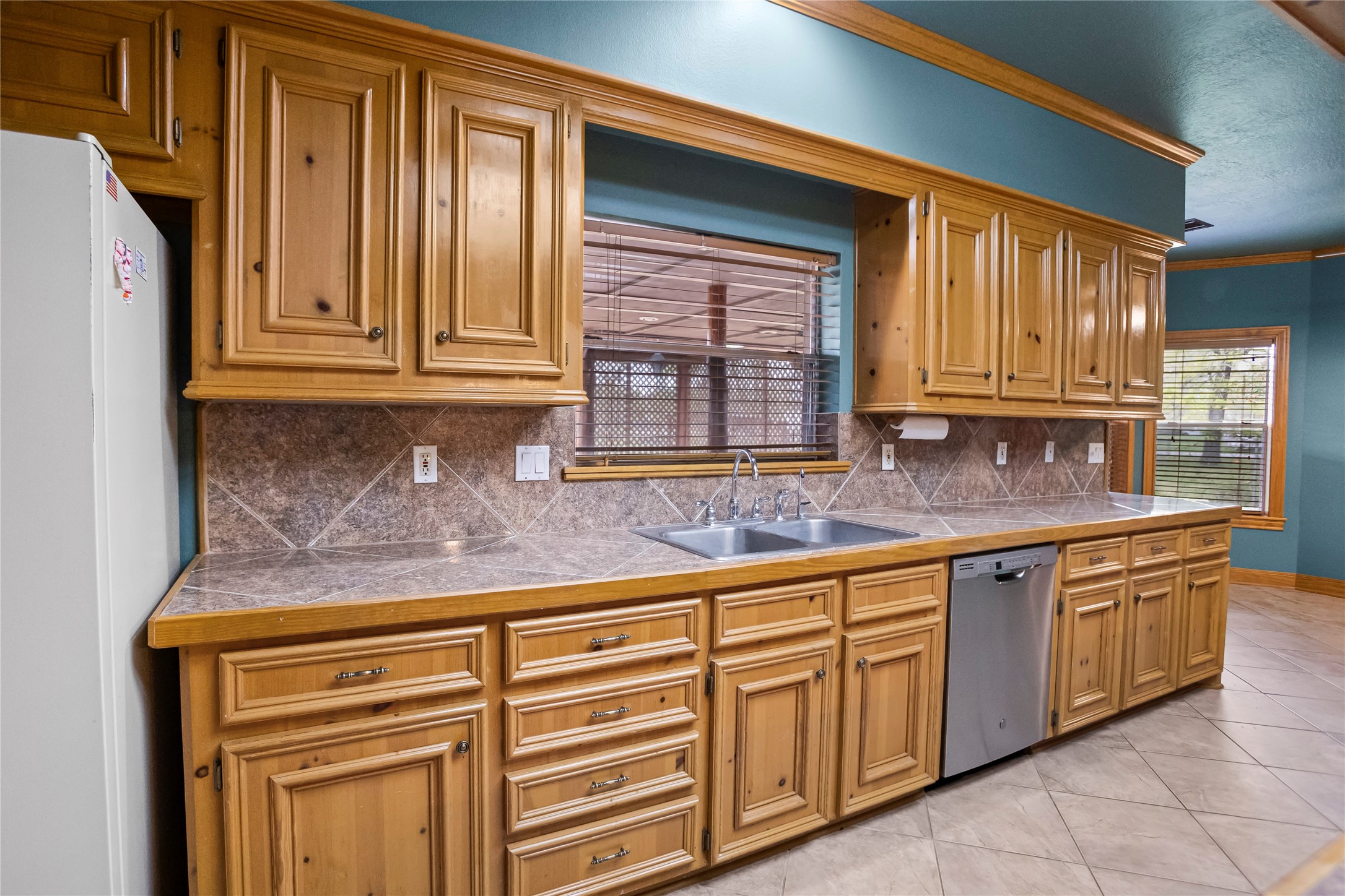 22916 East Martin Drive Porter, TX 77365 - Photo 11 of 43 a kitchen with granite countertop cabinets sink and window