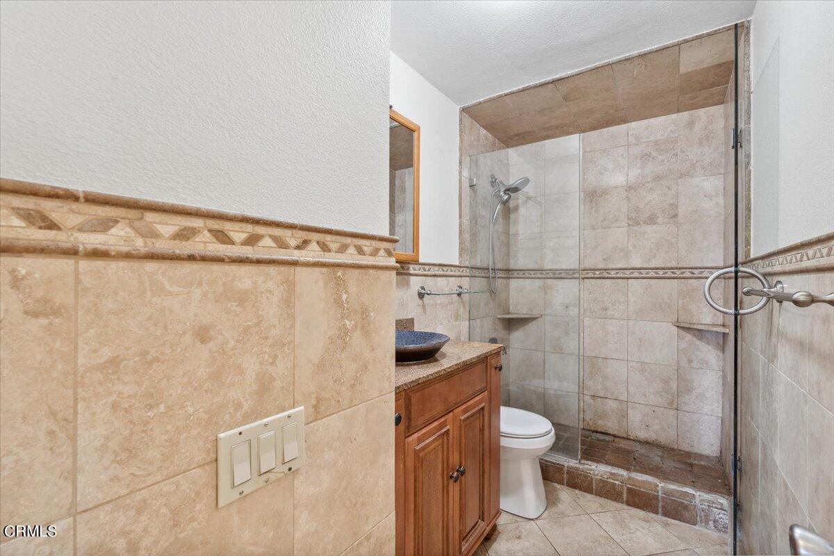 111 Bottlebrush Circle Oxnard, CA 93030 - Photo 15 of 44 a bathroom with a granite countertop shower a toilet and a sink