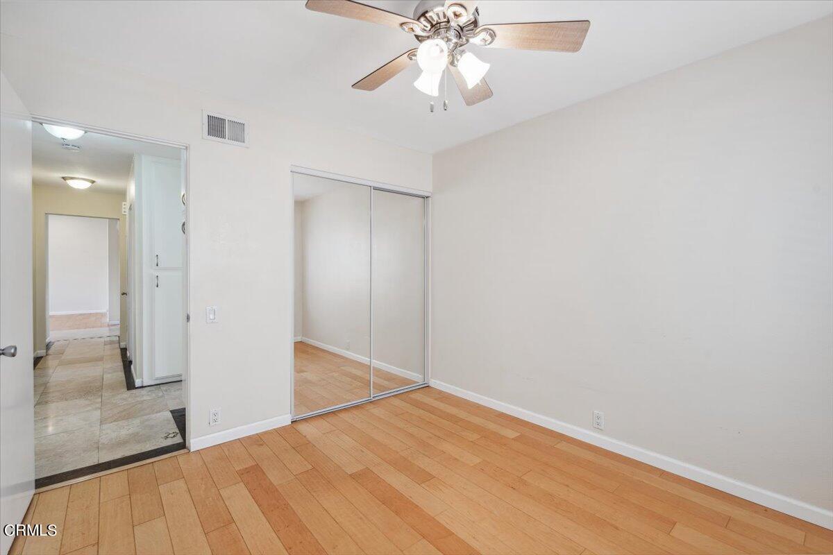 111 Bottlebrush Circle Oxnard, CA 93030 - Photo 20 of 44 wooden floor in an empty room with a chandelier fan