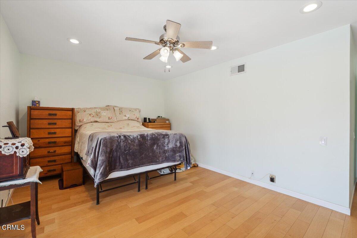 111 Bottlebrush Circle Oxnard, CA 93030 - Photo 23 of 44 a bedroom with a bed and a chandelier