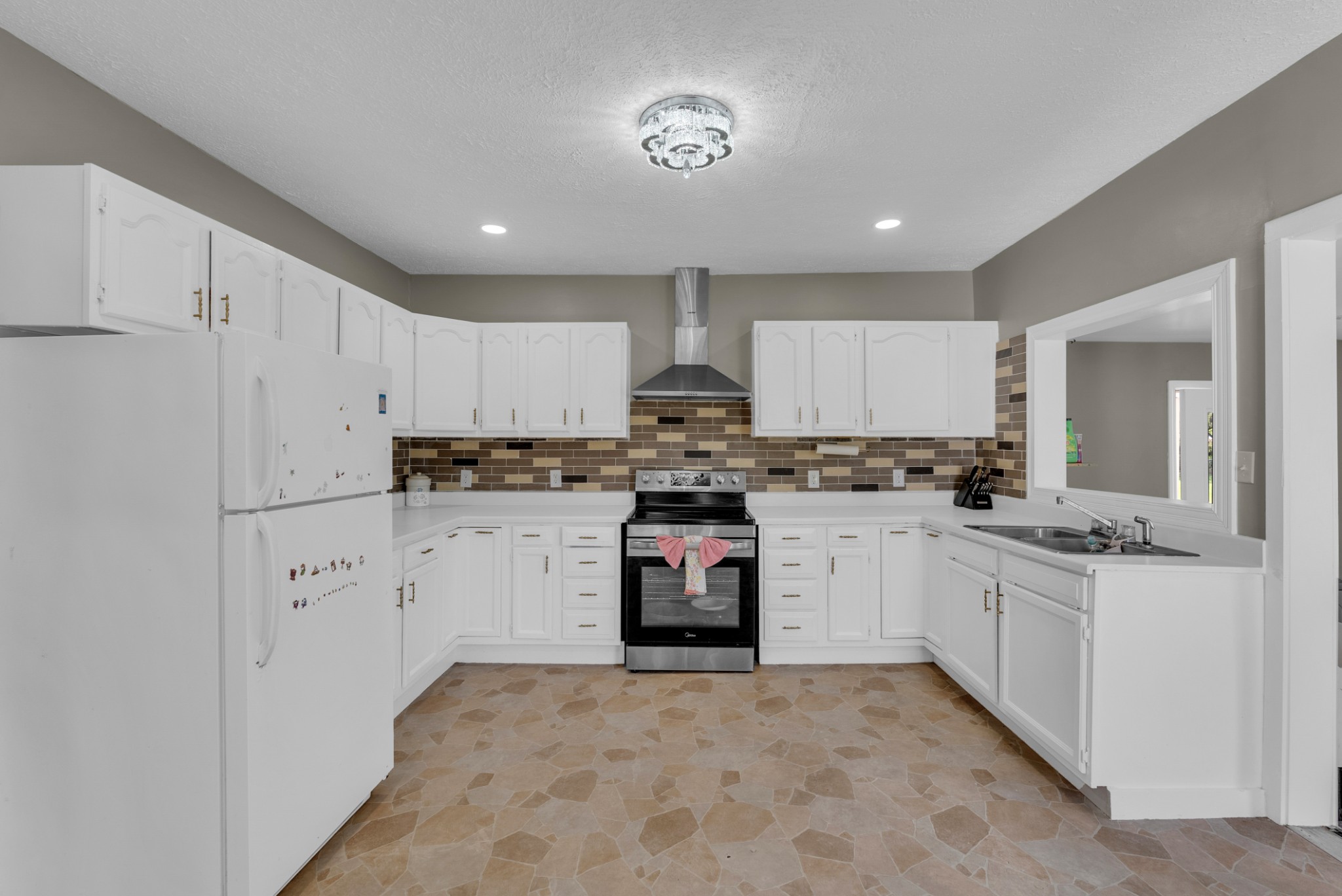 320 West King Street Morrison, TN 37357 - Photo 12 of 29 a kitchen with white cabinets and white appliances