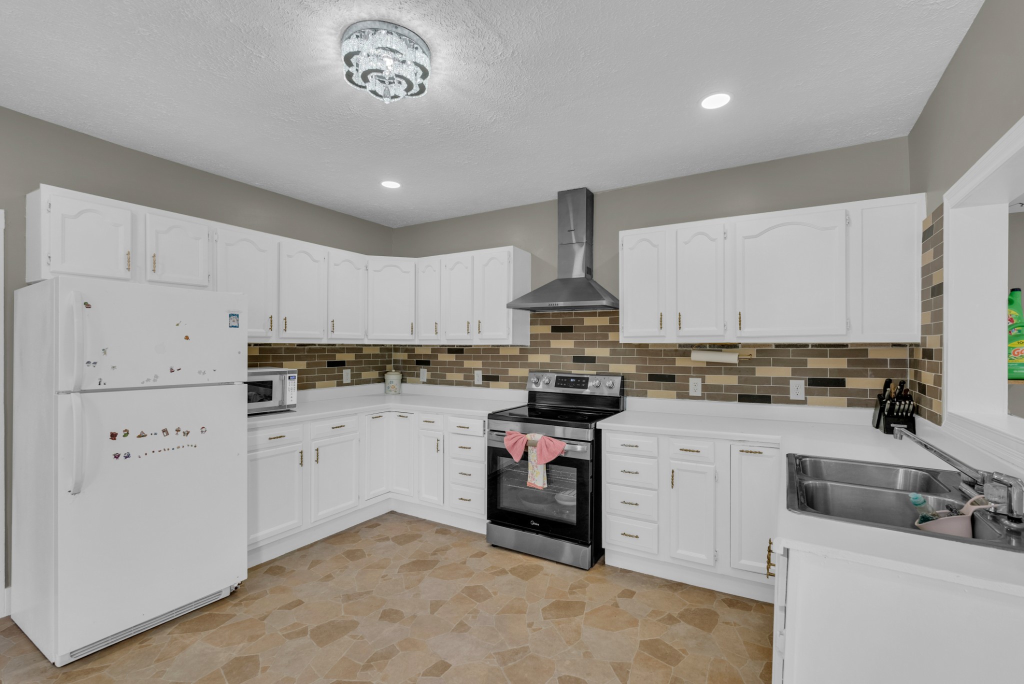 320 West King Street Morrison, TN 37357 - Photo 13 of 29 a kitchen with white cabinets appliances and a sink