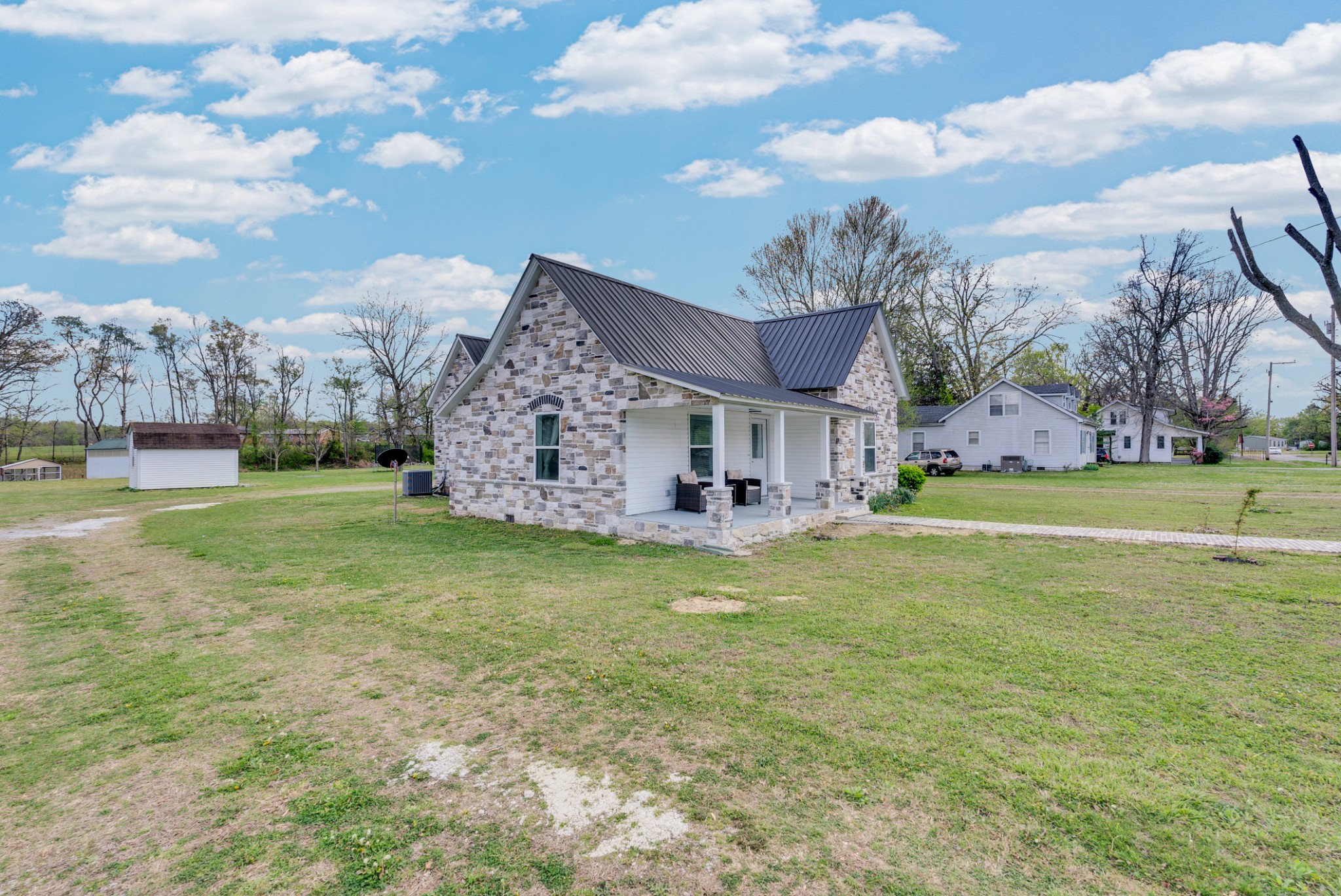 320 West King Street Morrison, TN 37357 - Photo 2 of 29 a view of a house with a big yard and a large tree