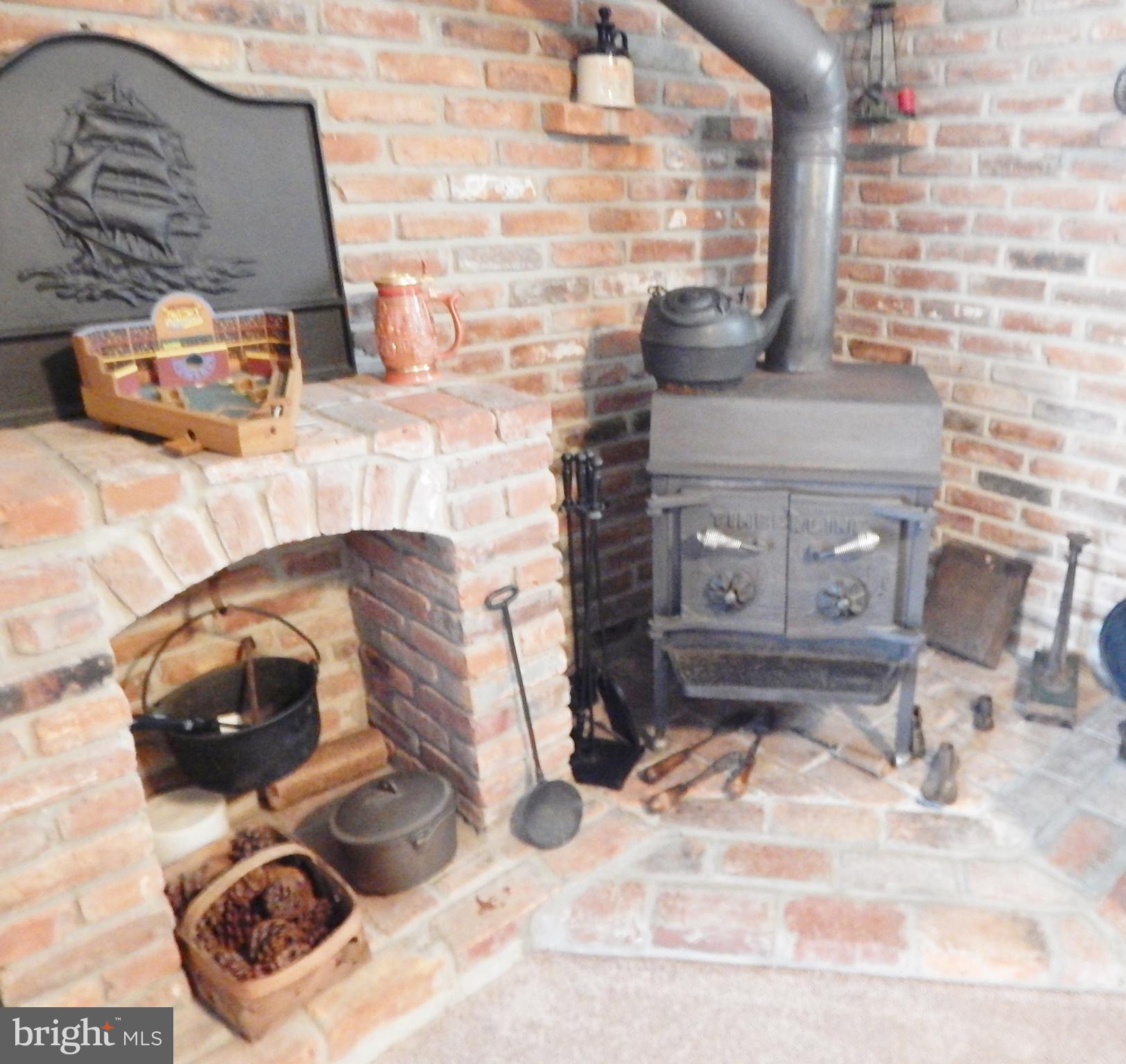 6053 Hill Road St. Leonard, MD 20685 - Photo 19 of 28 wood stove in family room lower level