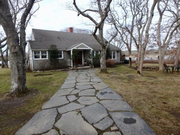 74 Turkeyland Cove Road Edgartown, MA 02539 - Photo 1 of 23 a front view of a house with a yard