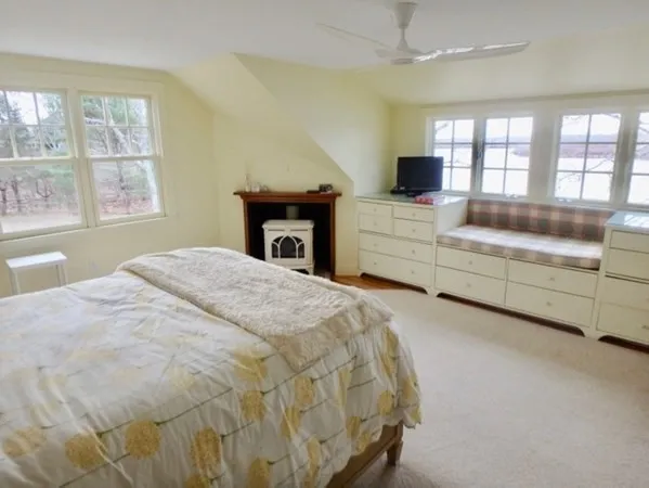 a spacious bedroom with a bed and a flat screen tv