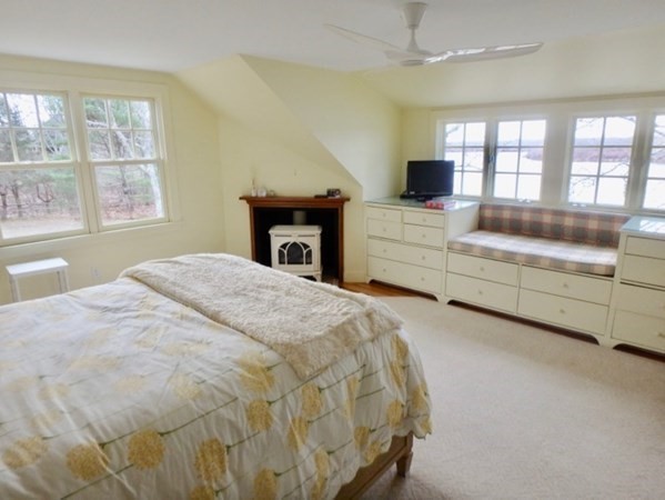 74 Turkeyland Cove Road Edgartown, MA 02539 - Photo 17 of 23 a spacious bedroom with a bed and a flat screen tv