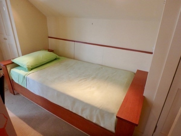 74 Turkeyland Cove Road Edgartown, MA 02539 - Photo 19 of 23 a bedroom with a bed and wooden floor