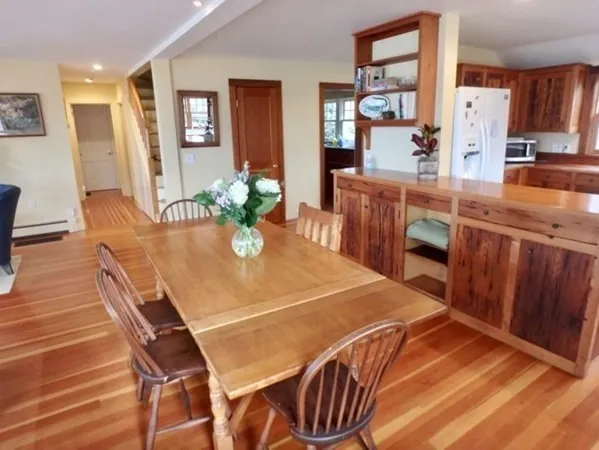 a dining room with furniture and wooden floor