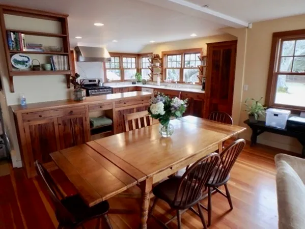 a view of a dining room with furniture and window