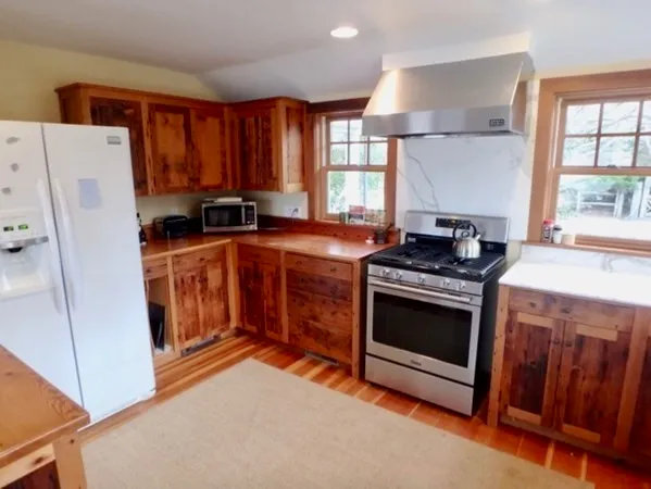 a kitchen with stainless steel appliances granite countertop a stove a refrigerator and a stove