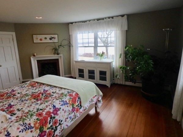 74 Turkeyland Cove Road Edgartown, MA 02539 - Photo 9 of 23 a bedroom with a bed and a fireplace