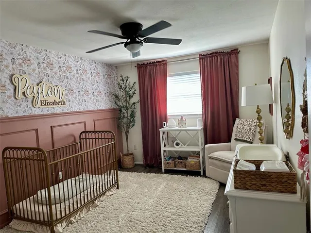 a view of white cabinets with a sink and wooden floor