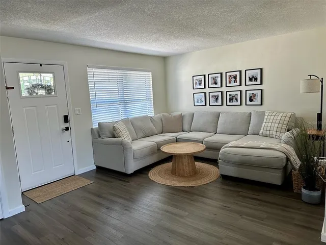 a kitchen with stainless steel appliances granite countertop a sink a stove and white cabinets