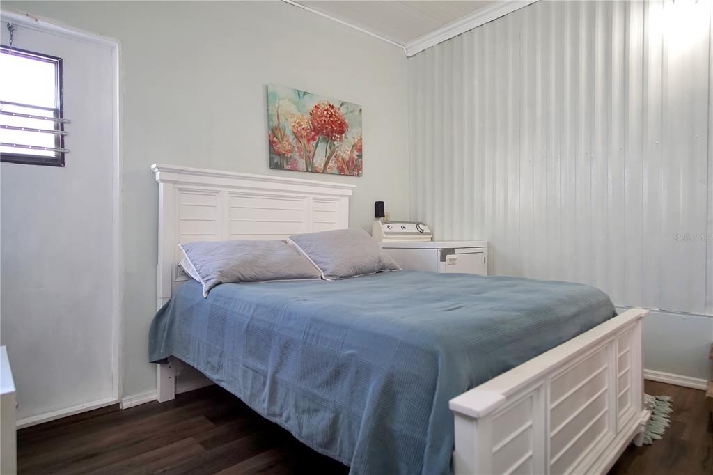 251 Patterson Road, Unit C13 Haines City, FL 33844 - Photo 15 of 28 a bedroom with a bed and a painting on the wall