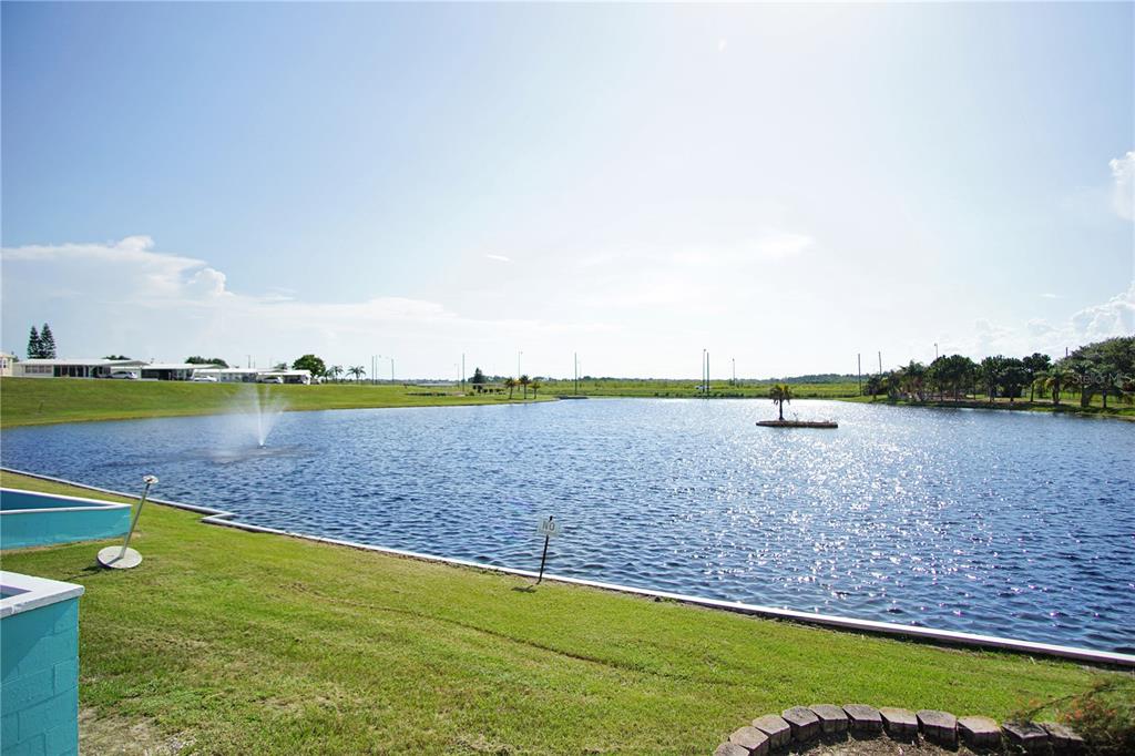 251 Patterson Road, Unit C13 Haines City, FL 33844 - Photo 22 of 28 a view of a lake with houses in the back