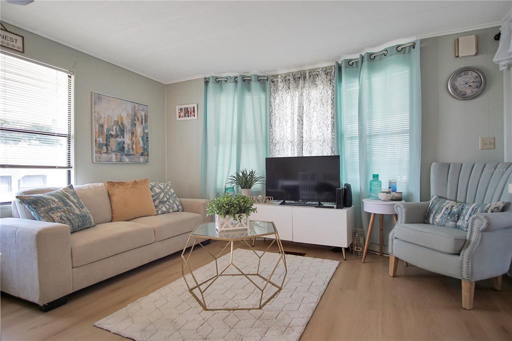 251 Patterson Road, Unit C13 Haines City, FL 33844 - Photo 4 of 28 a living room with furniture and a flat screen tv