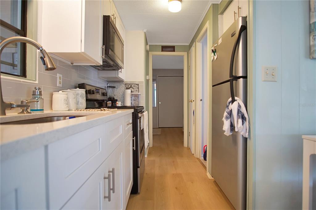 251 Patterson Road, Unit C13 Haines City, FL 33844 - Photo 7 of 28 a kitchen with cabinets and a refrigerator