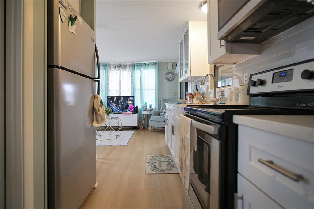 251 Patterson Road, Unit C13 Haines City, FL 33844 - Photo 8 of 28 a kitchen with stainless steel appliances granite countertop a refrigerator and a stove