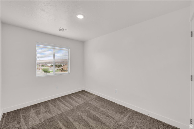 5875 Challenger Way St. George, UT 84790 - Photo 13 of 18 Room with neutral tone carpeting and white baseboards