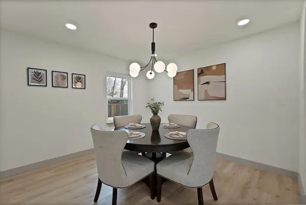 a dining room with furniture and wooden floor