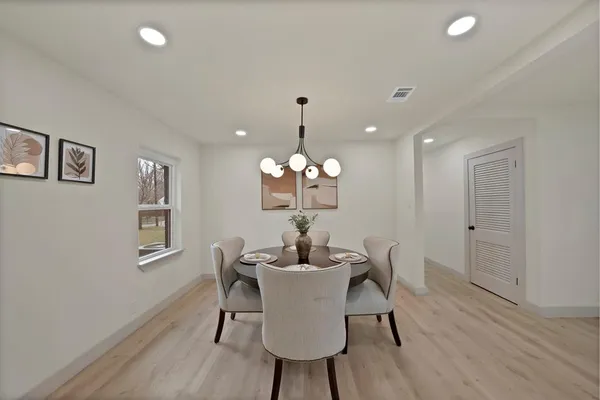 a dining room with wooden floor and breakfast area