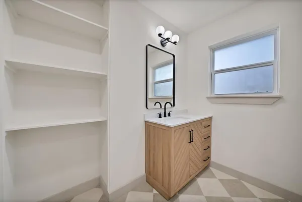 a bathroom with a sink a mirror and vanity